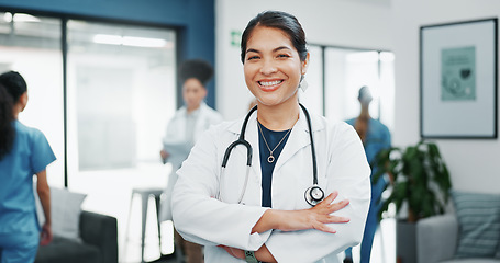 Image showing Face, doctor and arms crossed in busy hospital for about us, medical life insurance or wellness support. Smile, happy and healthcare woman in portrait, confidence trust or clinic medicine leadership