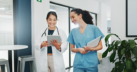 Image showing Talking doctor, walking or nurse on tablet in busy hospital teamwork, women collaboration or bonding with surgery joke. Smile, happy or laughing healthcare workers on medical technology meme or comic