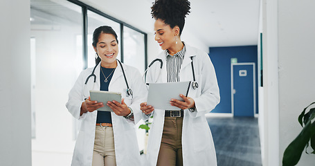 Image showing Talking doctors, walking or tablet in busy hospital, teamwork or collaboration for surgery planning, medicine or life insurance app. Smile, happy or planning healthcare women on technology research