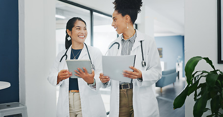 Image showing Talking doctors, walking or tablet in busy hospital, teamwork or collaboration for surgery planning, medicine or life insurance app. Smile, happy or planning healthcare women on technology research