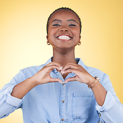 Image showing Black woman, heart hands and health with emoji, smile in portrait and love isolated on yellow background. Support, care and kindness with respect, happiness and wellness, romance sign in a studio