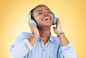 Image showing Black woman, happiness and headphones with music, energy and audio streaming isolated on yellow background. Sound, entertainment and radio with freedom, person with fun and technology in a studio