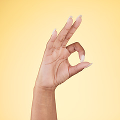 Image showing Perfect, ok and hand sign in studio with decision, agreement and success of good news. Yellow background, yes vote and accept approval of a person showing agree, opinion and emoji icon and signal