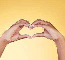 Image showing Woman, heart hands and symbol for love, support or care in trust against a studio background. Closeup of female person with loving emoji, gesture or sign in romance, valentines day or shape on mockup