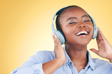 Image showing Singer, music and black woman on headphones, smile and listening in studio isolated on a yellow background. Excited, radio and African person streaming podcast, audio and sound, hearing and freedom.