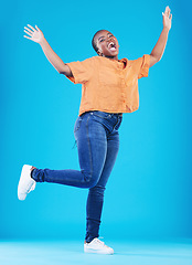 Image showing Winner, excited or portrait of black woman jump on blue background with energy, joy or smile in studio. Happy, celebration or African person screaming for freedom, success or winning lottery jackpot