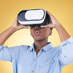 Image showing Black woman, surprise and virtual reality, metaverse and futuristic technology isolated on yellow background. VR goggles, wow and experience, digital world and gaming with cyber software in a studio