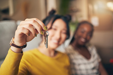 Image showing Hand, keys and new home or people moving in together for real estate investment. Rent, mortgage and loan closeup of women friends celebrate at apartment, property or house with a partner for freedom