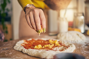 Image showing Hand, cheese and pizza for cooking, closeup and ready for food, restaurant or fast food with skill in Naples. Chef woman, dough and tomato sauce for cuisine, culture and preparation with process