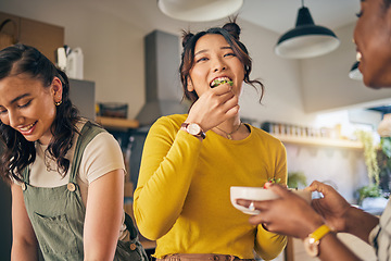 Image showing Women, friends and eating healthy food in home for bonding, nutrition and happy lunch together. Fruit diet, sharing and wellness, fresh summer friendship and girls in kitchen with smile at party.