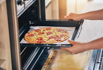 Image showing Hands, open oven and cooking pizza for food, restaurant or fast food with skill in home kitchen for baker in Naples. Chef person, dough and tomato sauce for cuisine, culture and preparation process