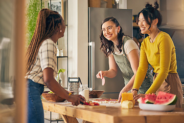 Image showing Friends, smile and women cooking pizza in kitchen, bonding and having fun together in home. Happy, girls and baking food, margherita and salami bread at lunch, cheese on meat and brunch in house