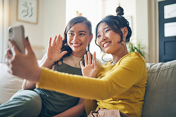 Image showing Phone, wave and friends on video call on sofa, communication and conversation in living room of home. Smartphone, hello and happy women in webinar, virtual chat and girl in online meeting in house