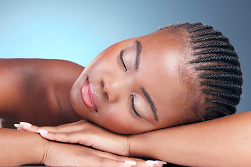 Image showing Skincare, relax and black woman in studio, sleeping and natural makeup with dermatology at luxury spa. Cosmetics, rest and dream facial beauty treatment with self care on blue background in Africa.