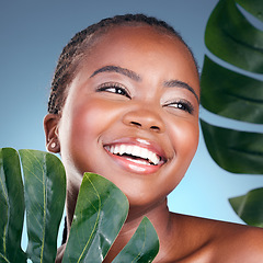 Image showing Beauty face, leaf and black woman happiness for natural self care, cosmetics or sustainable product. Studio, plant and clean African person with monstera, eco friendly and skincare on blue background