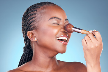 Image showing Studio, face and black woman with brush for makeup application, facial skincare or beauty routine. Cosmetics, spa dermatology and African person with cosmetology tools on blue gradient background