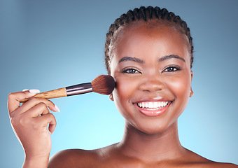 Image showing Studio portrait, happy black woman and makeup brush, product or cosmetology tools for facial powder application. Face cosmetics, beauty skincare shine and African person on blue gradient background