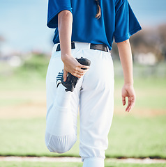 Image showing Back, softball and athlete stretching legs at field outdoor in healthy body exercise. Warm up, hands and person prepare in sports training, wellness workout and fitness to start game or competition