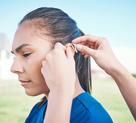 Image showing Hands, profile and woman in hearing aid, ear and sound amplifier at park outdoor. Help, person with a disability and deaf tools in audio communication, wear technology and listening on microphone