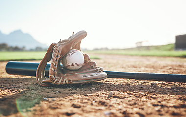 Image showing Glove, bat and baseball gear on a field for a game, professional competition or sports. Ground, fitness and equipment for a match, fitness or training for softball on the sand in summer for cardio