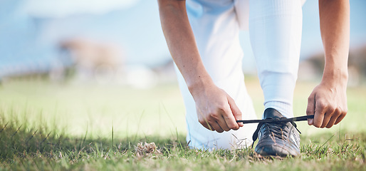 Image showing Hands, feet and a sports person tying laces on a baseball field outdoor with mockup space for fitness. Exercise, shoes and getting ready with an athlete on a pitch for a match or training closeup