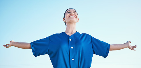 Image showing Woman, arms out and winning, softball and athlete on outdoor, celebration and success with sports. Blue sky, freedom and happiness, baseball player and fitness with achievement, cheers and winner