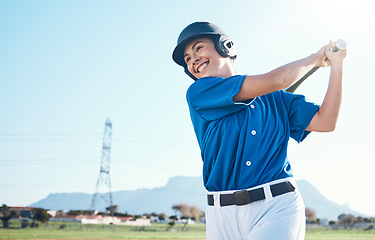 Image showing Baseball, bat and swing of a woman outdoor on a pitch for sports, performance and competition. Professional athlete or softball player with a smile, space and ready for game, training or exercise