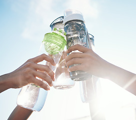 Image showing Hands, water bottle and toast to fitness together after workout, exercise or training outdoor with team of players. Sport, goals and cheers with group and liquid for hydration, celebration and unity