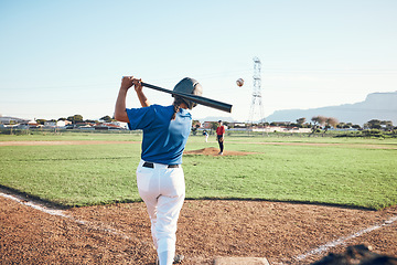 Image showing Baseball, bat and person swing at ball outdoor on a pitch for sports, performance and competition. Behind athlete or softball player ready for game, training or exercise challenge at field or stadium