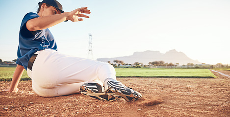 Image showing Slide, baseball action and player in dirt for game or sports competition on a pitch in a stadium. Man, ground and tournament performance by athlete or base runner in training, exercise or workout