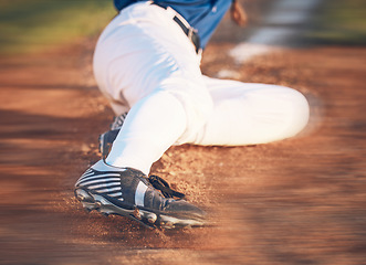 Image showing Slide, baseball action and athlete in a dirt for game or sports competition on pitch in stadium. Person, ground and tournament performance by athlete or base runner in training, exercise or workout