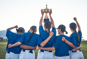 Image showing Baseball, trophy and team celebrate win with women outdoor on a pitch for sports competition. Behind professional athlete or softball player group show champion prize, award or achievement at a game