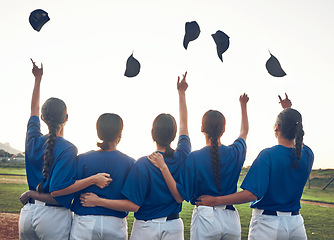 Image showing Baseball player, team and celebrate win outdoor with women on a pitch for sports competition. Behind professional athlete or softball group with success, winning or achievement and throw cap at game