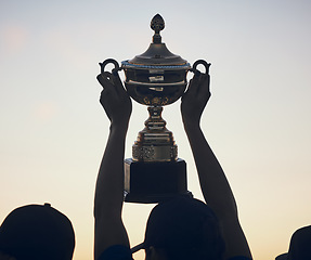 Image showing Sunset, trophy in hands and silhouette and team with sports, athlete group and people outdoor with celebration. Winning, club and success with prize, reward and bonus, sky and support and achievement