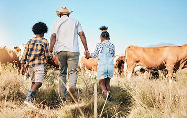 Image showing Farm, cows and father holding hands with children in countryside for ecology, adventure and vacation. Family, sustainable farming and back of dad with kids for bonding, relax and learning with animal