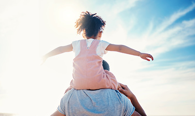 Image showing Child on father shoulders, beach and family with love, travel and back view with freedom and fun together outdoor. Nature, adventure with man and young girl bond on tropical holiday and sunshine