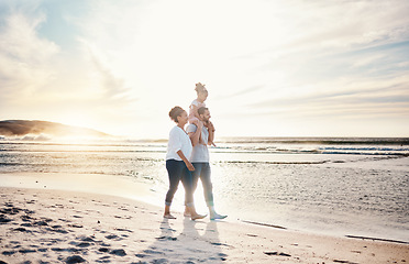 Image showing Walking, sunset and family on the beach for vacation, adventure or holiday together for bonding. Travel, having fun and girl child with her mother and father on the sand by the ocean on weekend trip.