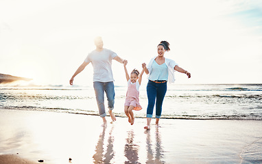 Image showing Mom, dad and swing girl on beach, holiday and vacation in Florida for bonding, adventure and family together in waves. Mother, father and child at sunset in ocean, sea or playing in water for fun