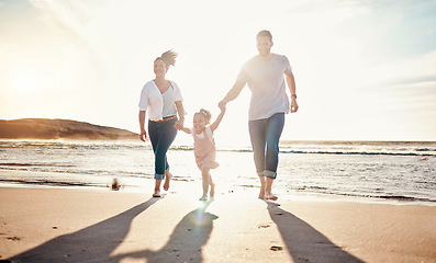 Image showing Family, beach and holding hands, parents and kid with travel and bonding, love and walking together in nature. Vacation, ocean and happy people outdoor, parents and child with sun and adventure