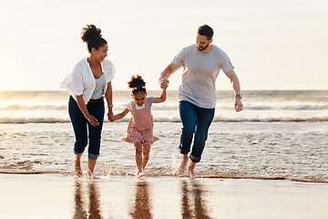 Image showing Family, running and ocean, beach and sunset, happiness and fun together with games and bonding on vacation. Travel, adventure and playful, parents and child, happy people in nature and holding hands