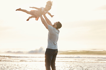 Image showing Beach, fly and father with girl, sunset and vacation with quality time, bonding and getaway trip. Male parent, kid and female child with seaside holiday, airplane and playing with fun and adventure