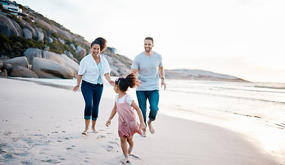 Image showing Family, running and happiness on beach, travel with mother, father and kid outdoor, fun together with games and bonding. Travel, adventure and playful, parents and child with happy people and energy