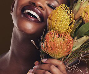 Image showing Smile, beauty and protea with the face of a black woman in studio on brown background for natural treatment. Skincare, plant or cosmetics and a young model aesthetic wellness with eco flowers