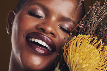 Image showing Skincare, beauty and plant with the face of a black woman in studio on brown background for natural treatment. Smile, protea or cosmetics and a young model indoor for aesthetic wellness with flowers