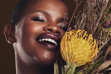 Image showing Skincare, beauty and protea with the face of a black woman in studio on brown background for natural treatment. Smile, plant or cosmetics and a young model for sustainability or wellness with flowers