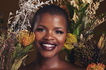 Image showing African woman, flowers and makeup in studio portrait with beauty, wellness or natural glow by brown background. Girl, model and face with leaves, plants and happy for cosmetics, skincare or aesthetic