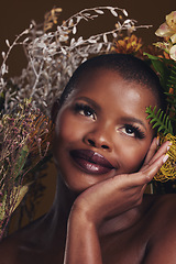 Image showing African woman, plants and thinking in studio with flowers for beauty, wellness or natural glow by brown background. Girl, model and face with leaves, ideas and memory for cosmetics, skin or aesthetic