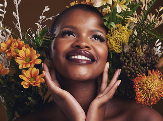 Image showing African woman, plants and ideas in studio with flowers for beauty, wellness or smile for glow by brown background. Girl, model and face for thinking, leaves or memory for cosmetics, skin or aesthetic