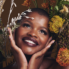 Image showing African woman, plants and thinking for aesthetic in studio with flowers for beauty, wellness and glow by brown background. Girl, model and smile on face for idea, leaves or memory with skin cosmetics