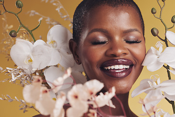 Image showing Black woman, flowers and beauty with smile, makeup and natural cosmetics isolated on studio background. African model, orchid and nature, sustainable skincare with eyes closed, facial and glow